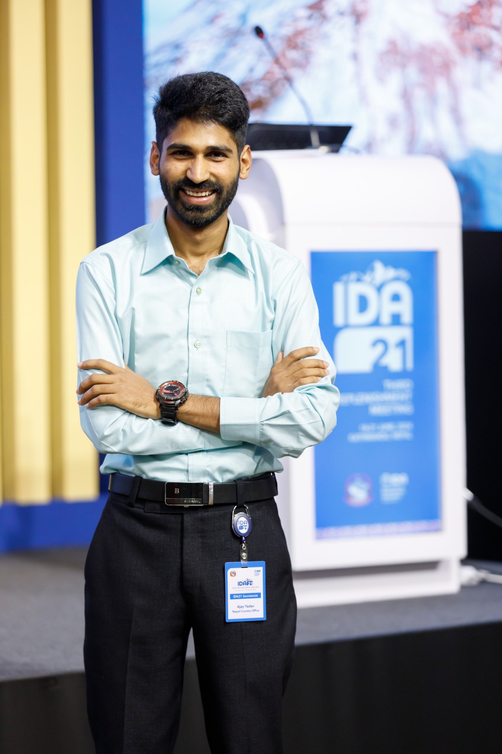 Ajay speaking at a lectern.
