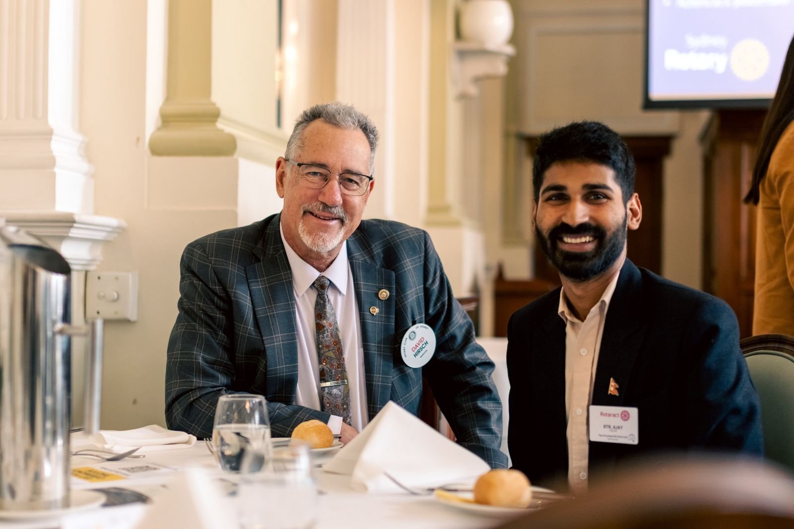 Ajay in conversation with someone across a table.