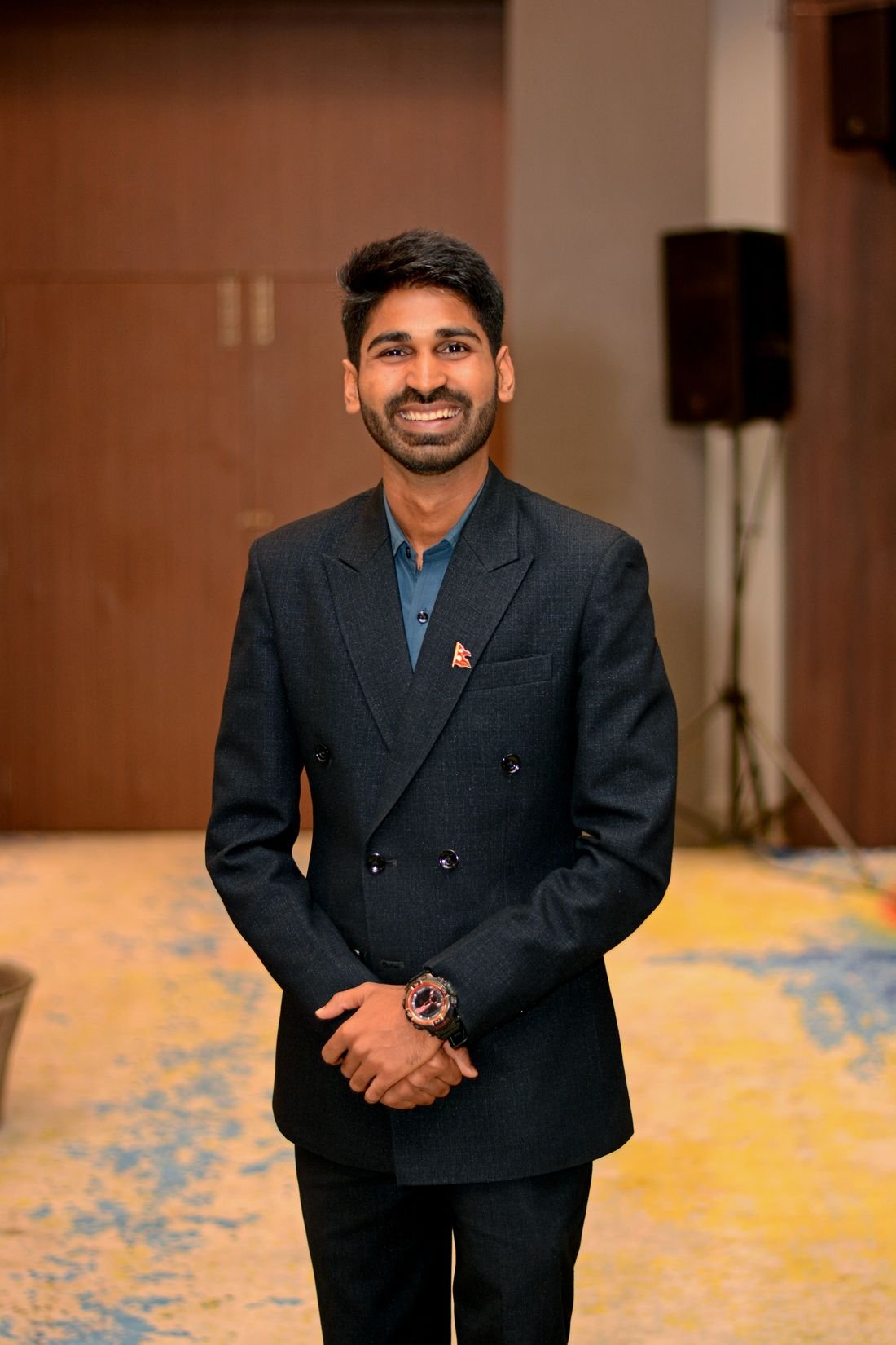 Ajay Yadav standing in a warm room, looking towards the camera.